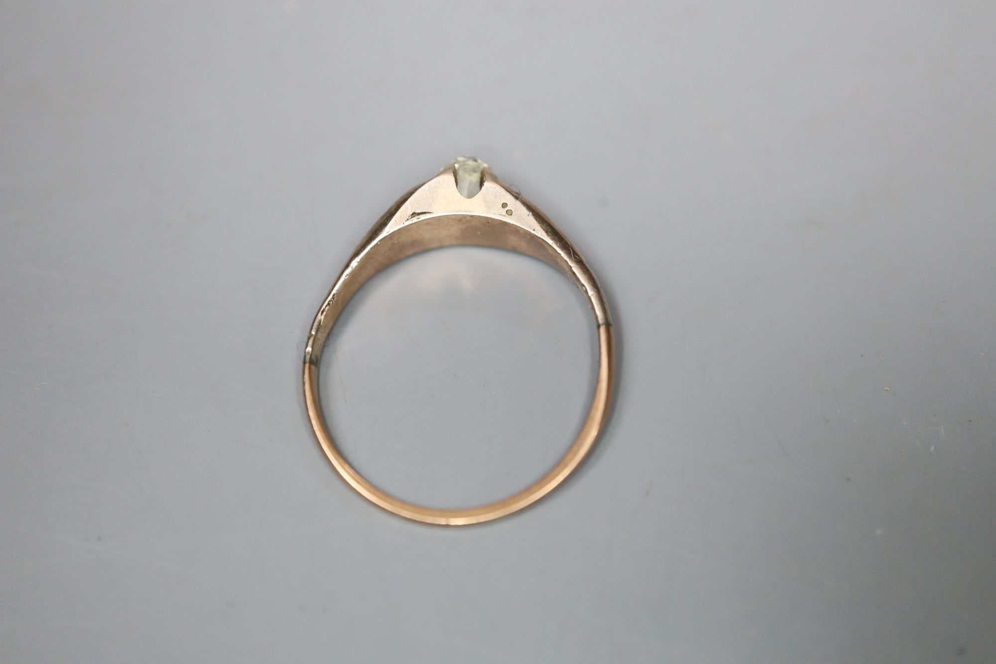 An Edwardian gold claw set solitaire diamond ring